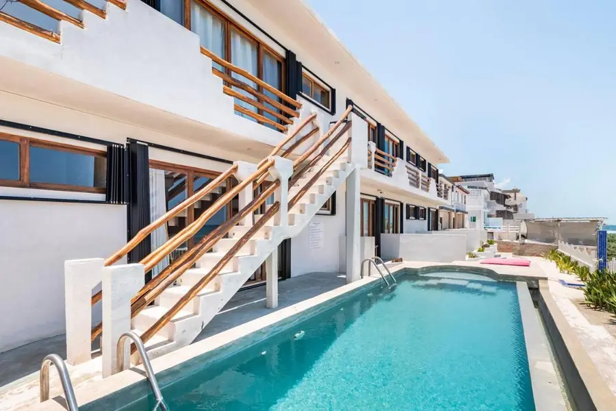 The villas of Villas Najo' with the pool and the white staircase, facing the sea, on Isla Mujeres, Mexico