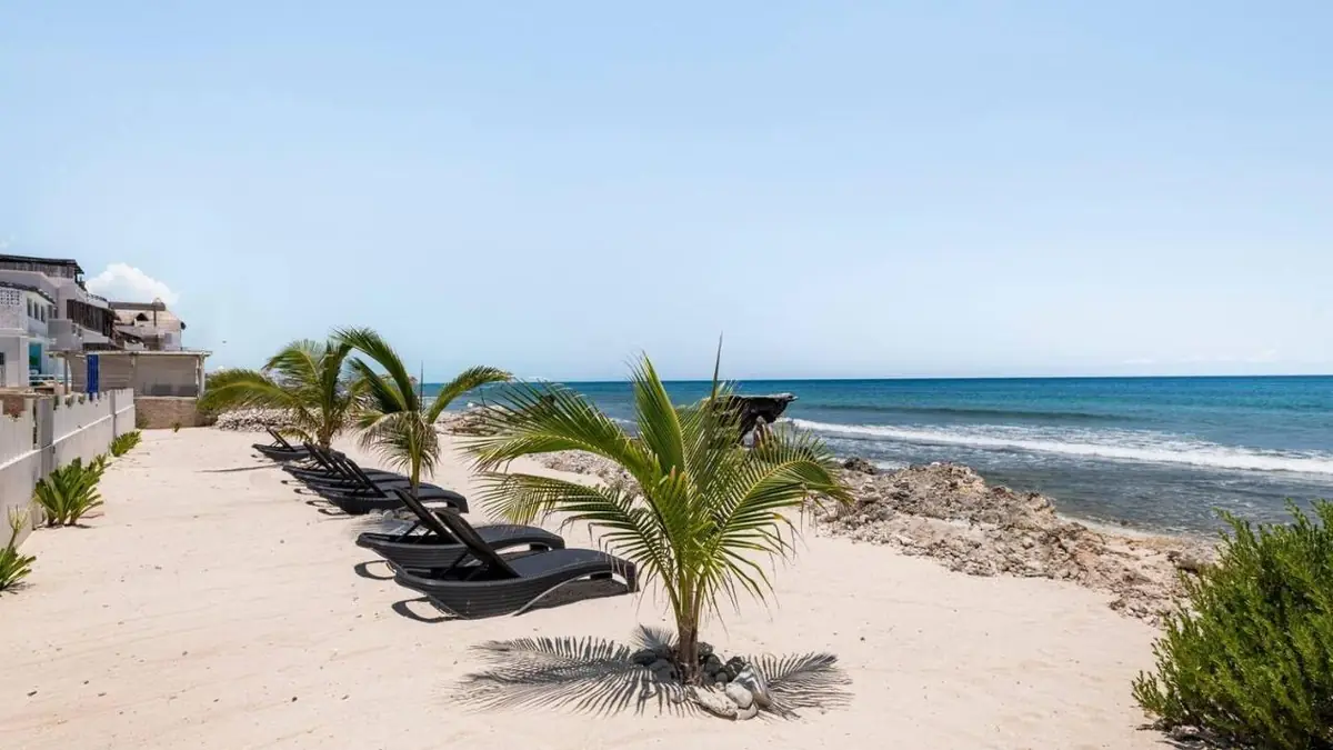 Loungers on the sand in front of Villas Najo'